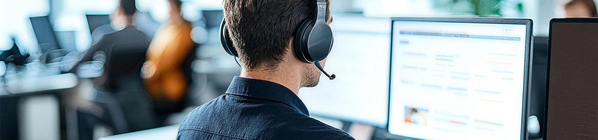 Man with headset at computer